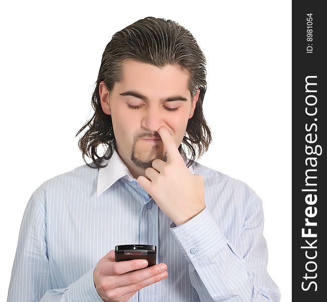 Young funny dark haired guy in light blue shirt dials on his mobile phone and picks his nose isolated on white. Young funny dark haired guy in light blue shirt dials on his mobile phone and picks his nose isolated on white