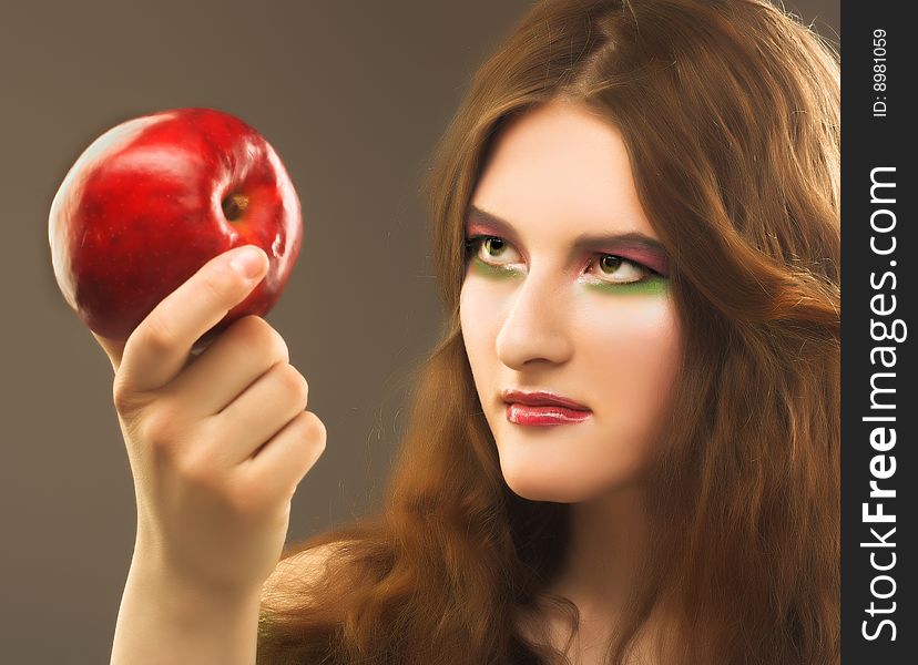 Portrait of young girl witn fresh red apple in her hand. Portrait of young girl witn fresh red apple in her hand