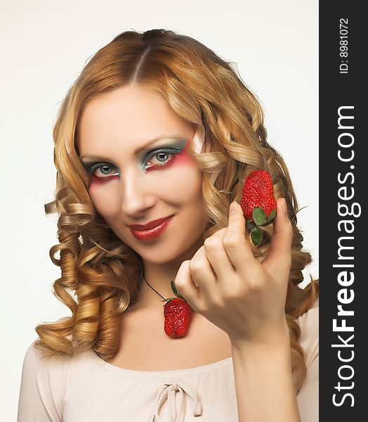 Portrait of pretty blonde with fresh strawberry. Portrait of pretty blonde with fresh strawberry