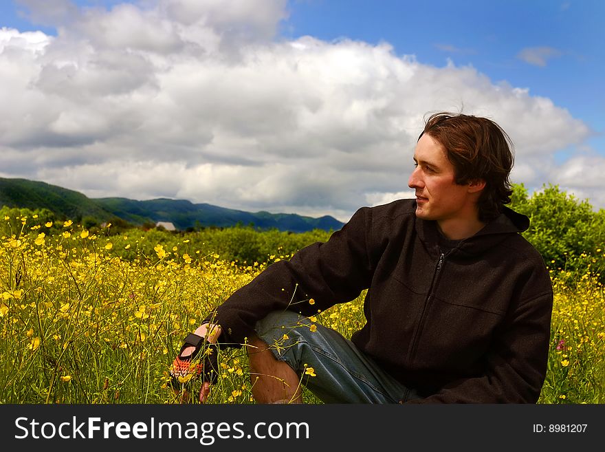 Young Man On Yellow Meadow In Sunny Weather