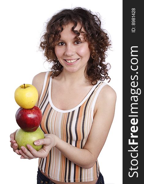 Young smiling woman with three apples. Attractive girl is holding the pyramid of apples. Isolated over white. Young smiling woman with three apples. Attractive girl is holding the pyramid of apples. Isolated over white.