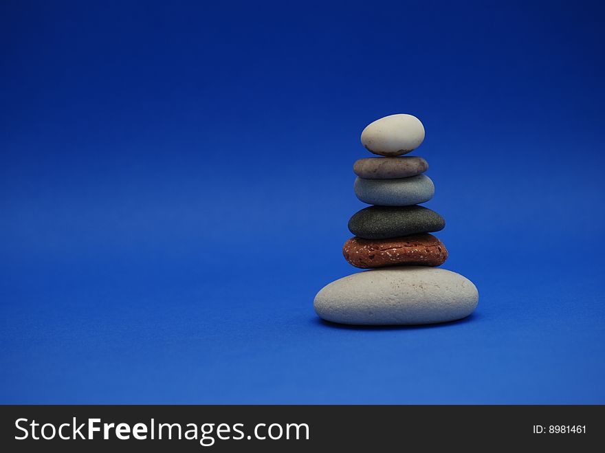 Stack of stones on blue background. Stack of stones on blue background