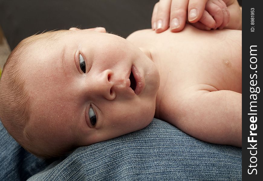 Newborn baby boy lying on mom's lap. Newborn baby boy lying on mom's lap