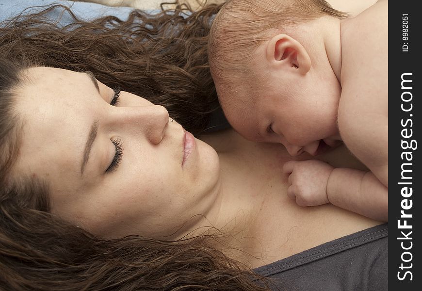 Newborn baby boy resting on mom's chest. Newborn baby boy resting on mom's chest