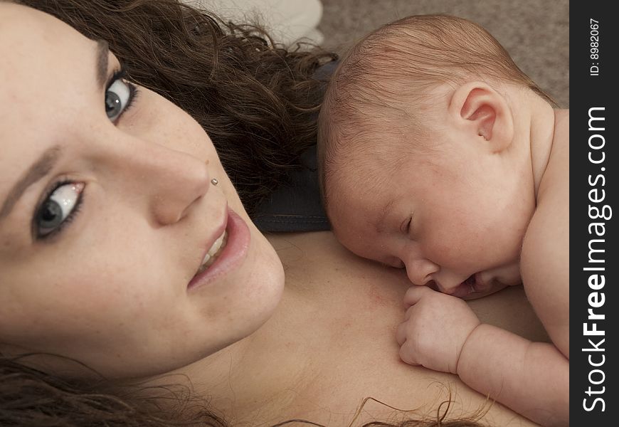 Newborn baby boy resting on mom's chest. Newborn baby boy resting on mom's chest