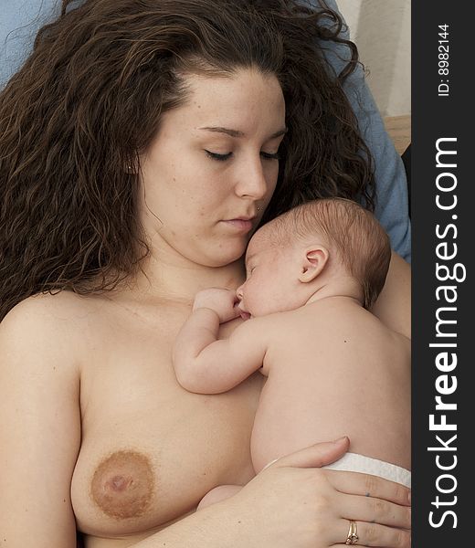 Newborn baby boy resting on mom's bare chest. Newborn baby boy resting on mom's bare chest