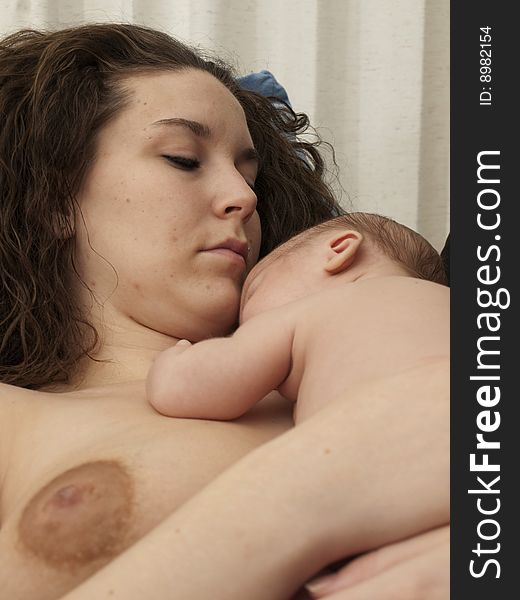 Newborn baby boy resting on mom's bare chest. Newborn baby boy resting on mom's bare chest