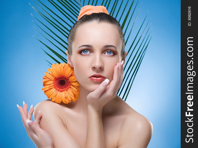 Portrait of beautiful woman with the orange flower. Portrait of beautiful woman with the orange flower.