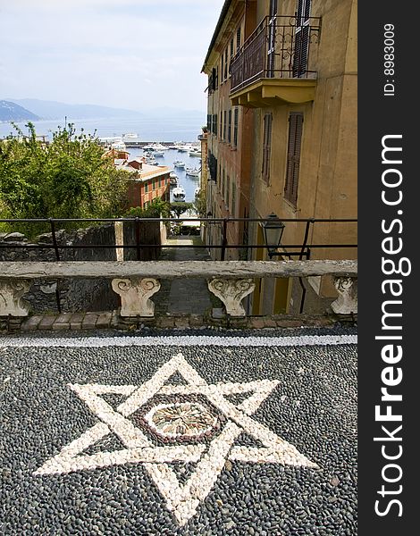 Landscape of Italian Riviera and a mosaic star to the fore