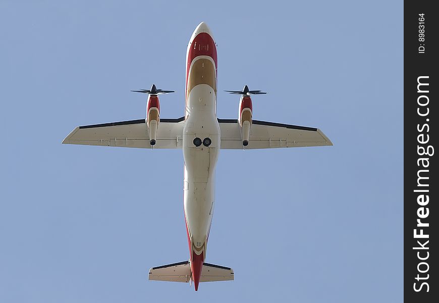 Dornier 328 airliner bottom view directly over head in flight. Dornier 328 airliner bottom view directly over head in flight