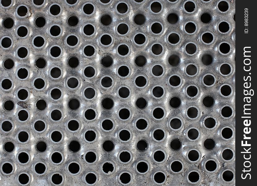 Metal plate background with holes for multiple uses