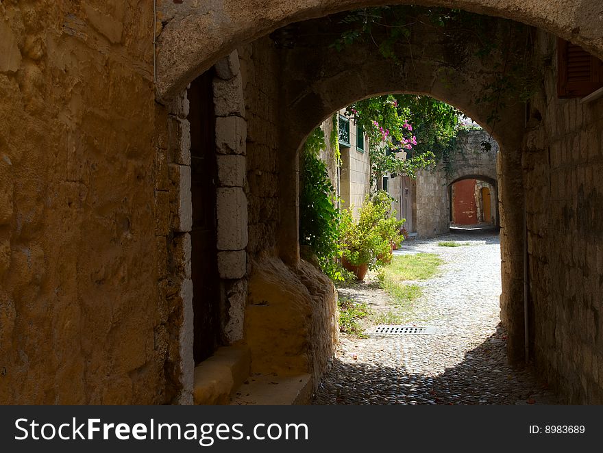 The view down a back alley in the old town, Rhodes, Greece. The view down a back alley in the old town, Rhodes, Greece.