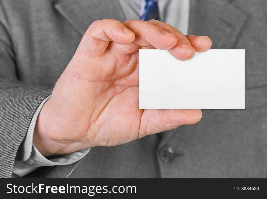 Paper card in hand, business background