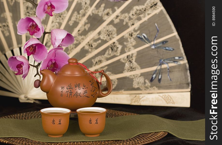 Chinese teapot and antique fan horizontal