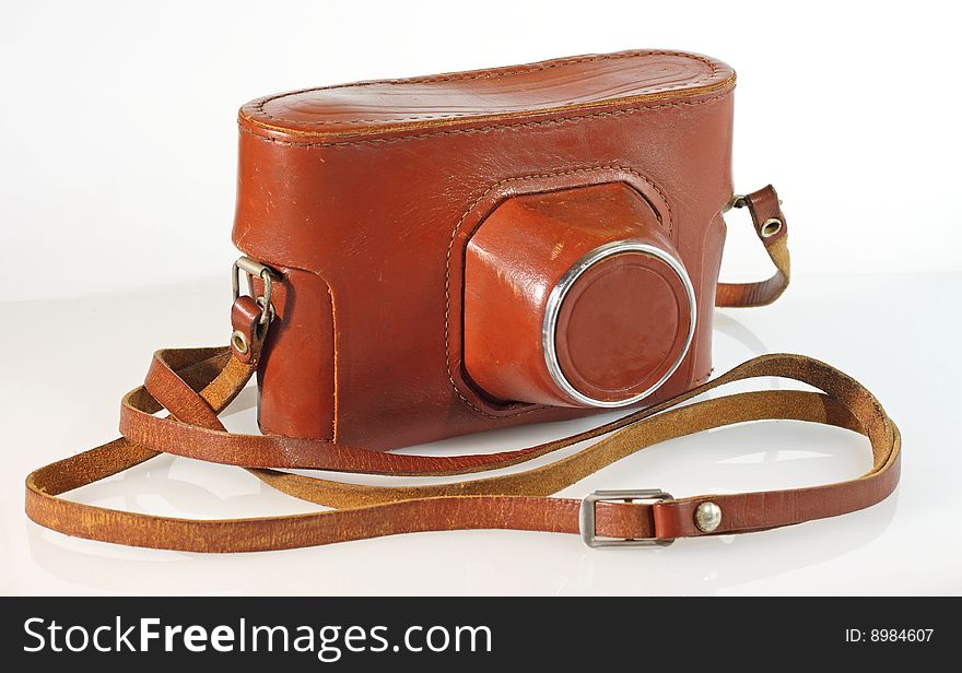 Old photo camera leather case isolated on white with reflection. Old photo camera leather case isolated on white with reflection
