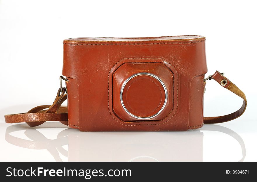 Old photo camera leather case isolated on white with reflection. Old photo camera leather case isolated on white with reflection