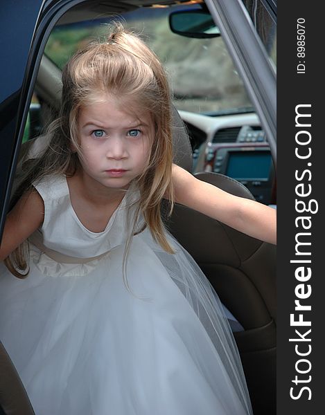 Young girl exiting the car for the wedding. Young girl exiting the car for the wedding