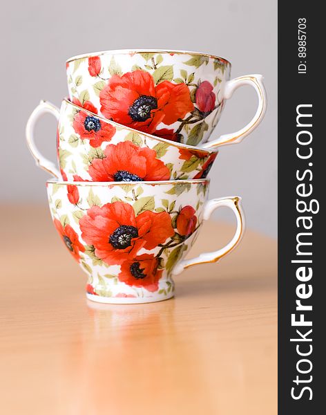 Three cups for coffee with poppies