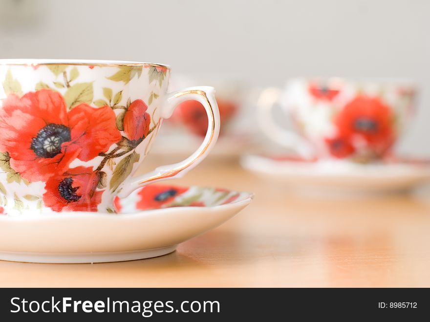 Cup for coffee with poppies and background of other cups