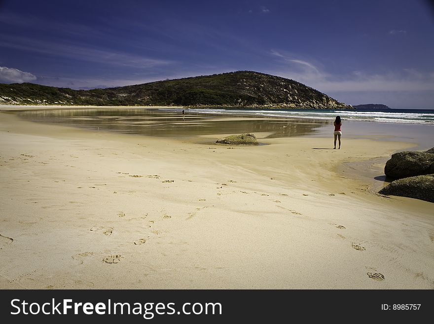 Vast Australian beach with a person in the distance. Vast Australian beach with a person in the distance