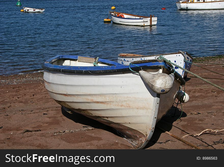 Wooden dinghy lying on beach. Wooden dinghy lying on beach