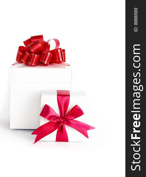 Box with red ribbon on white background