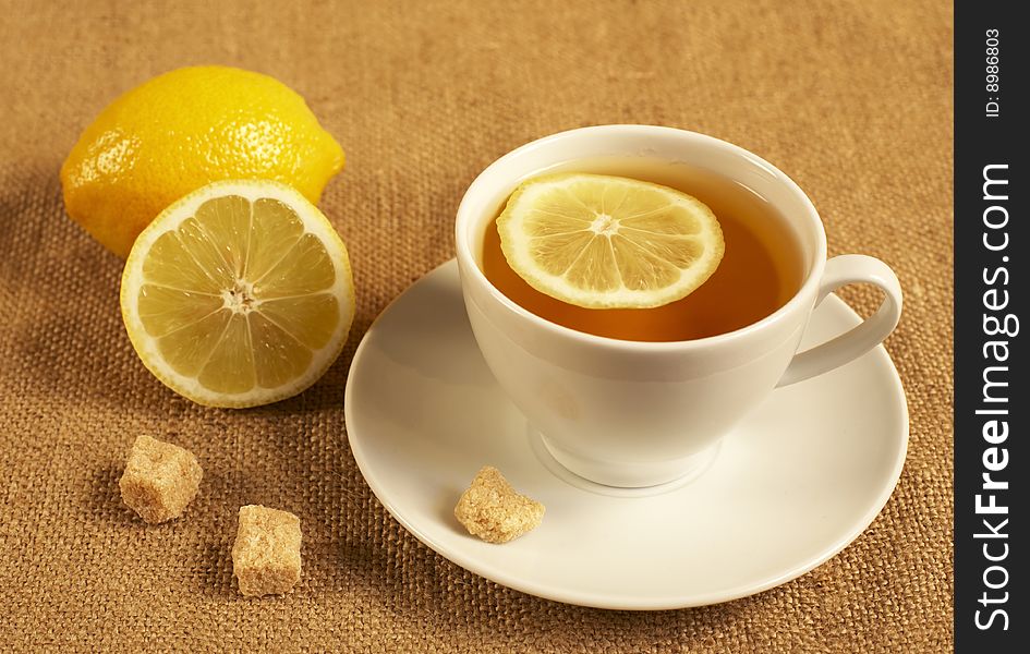 tea with lemon and sugar on the textile background