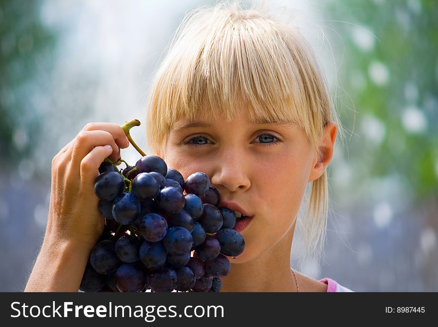 Summer vacation, schoolgirl tasty a grapes