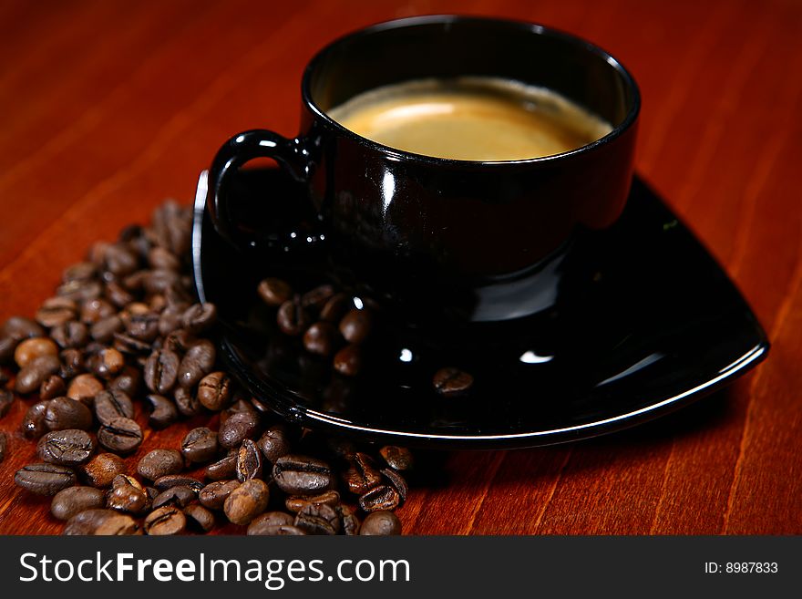 Cup with hot coffee on a brown background