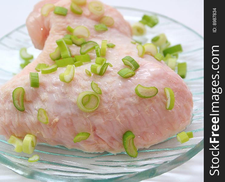 Fresh, raw chicken wings with spring onions. Fresh, raw chicken wings with spring onions