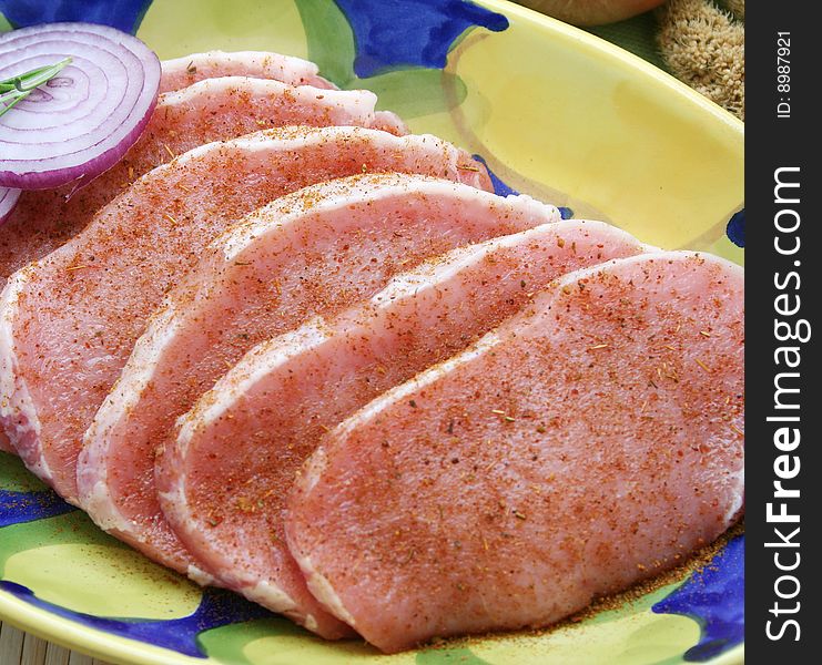 Some slices of fresh pork meat with spices. Some slices of fresh pork meat with spices