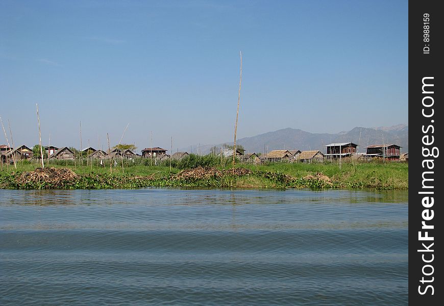 Lakeside village by ripple of wave. Myanmar, Burma.