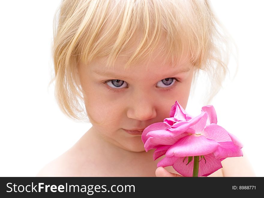 The little blonde girl holding a rose in hand. The little blonde girl holding a rose in hand