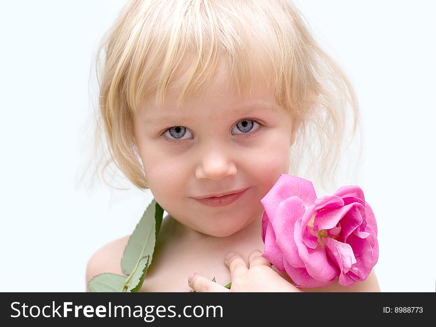 The little blonde girl holding a rose in hand. The little blonde girl holding a rose in hand