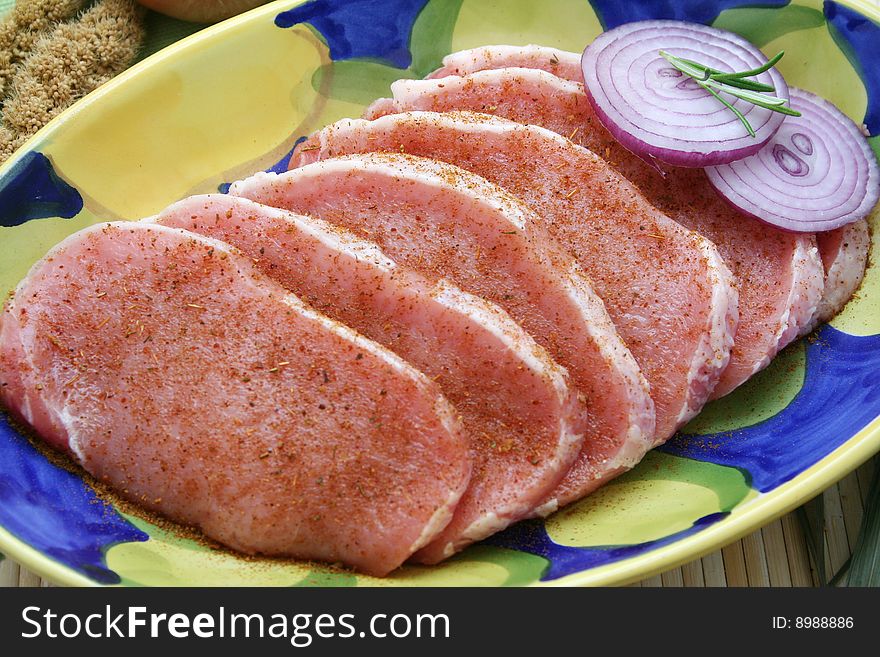 Some slices of fresh pork meat with spices. Some slices of fresh pork meat with spices