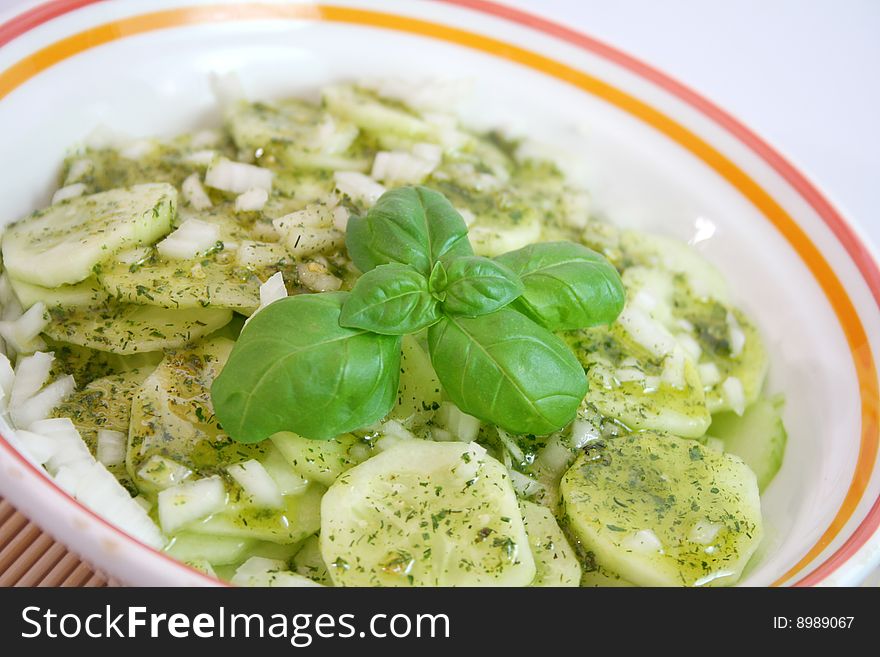 A fresh salad of cucumbers with onions and basil