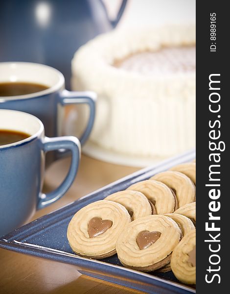 Coffee and heart shaped cookie on table