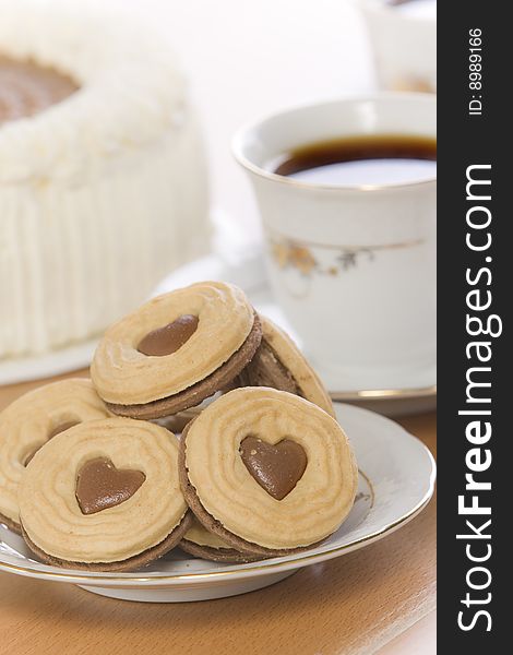 Coffee and heart shaped cookie on table