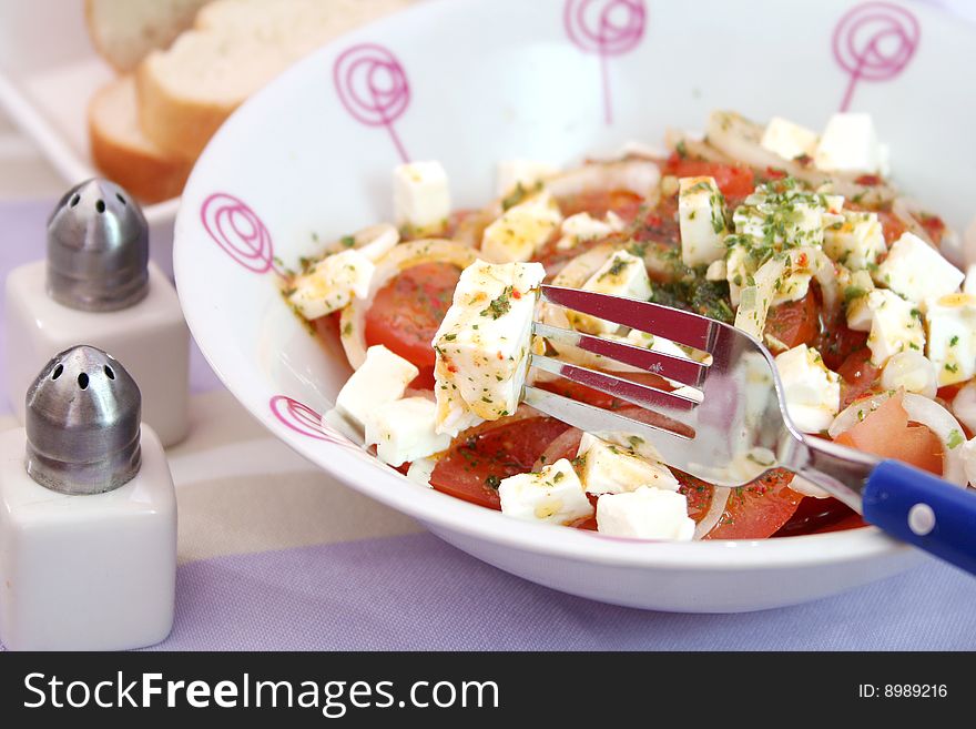 A fresh salad of tomatoes with cheese and onions