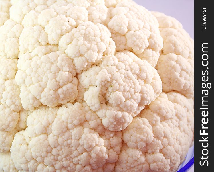 A close up of a white cauliflower in a bowl