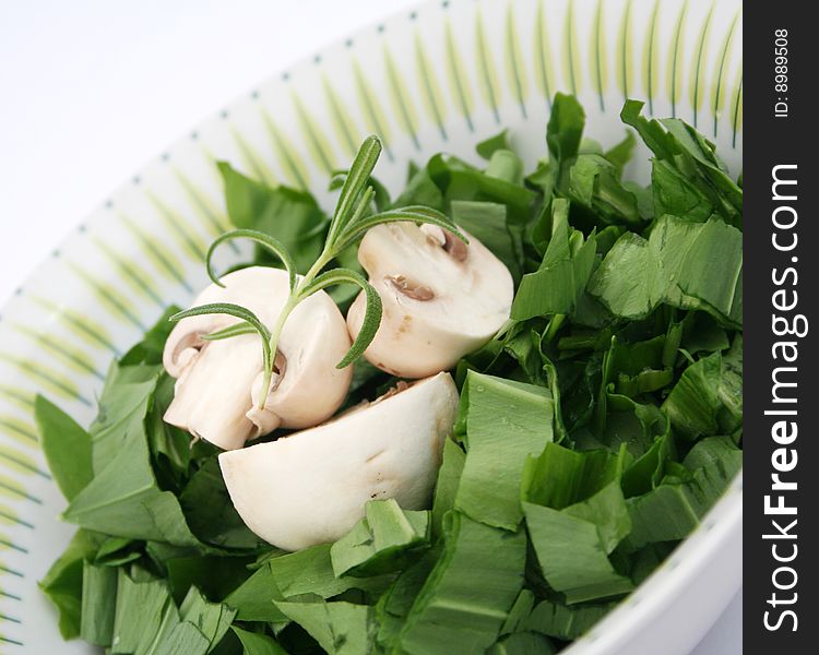 Fresh ramson with white mushrooms in a bowl. Fresh ramson with white mushrooms in a bowl