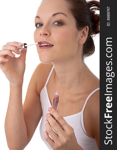 Body care - Young woman apply lipstick on white background