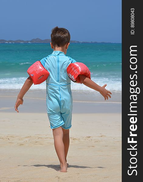 Boy on Blue Onesie on Beach during Day