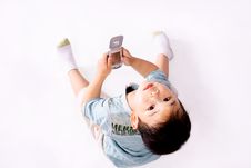 Boy Looking Upward With Cell Phone Royalty Free Stock Image