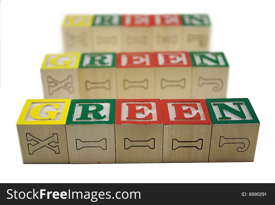 Toy alphabet blocks spelling 3 rows of fading Green. Toy alphabet blocks spelling 3 rows of fading Green