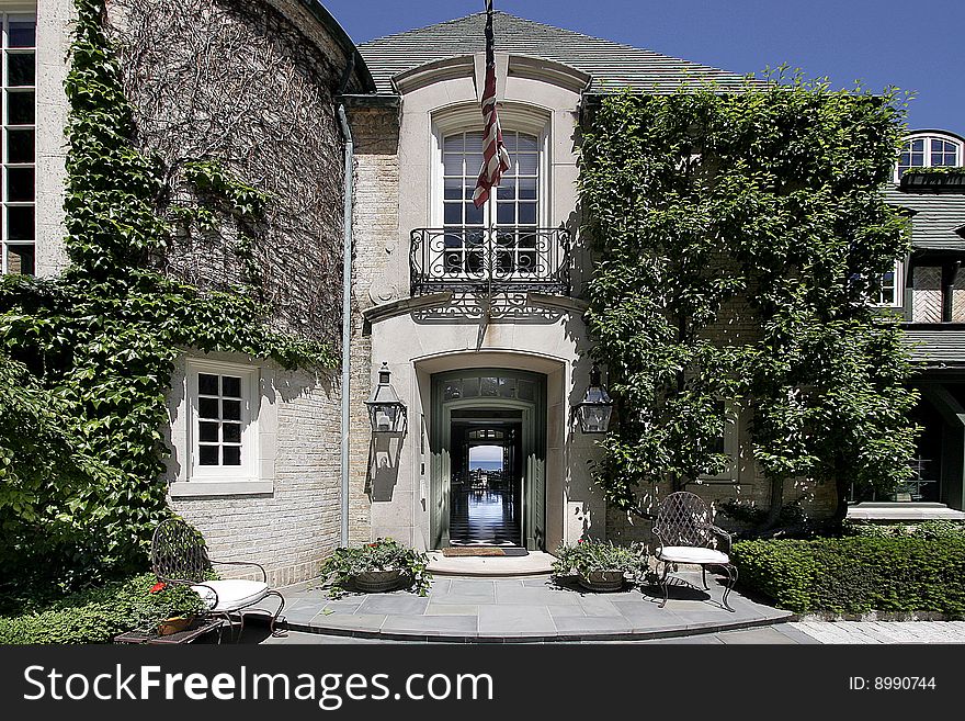 Outside entry of luxury home with view to lake. Outside entry of luxury home with view to lake