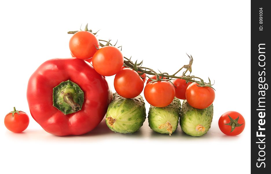 Mix of pepper, cucumbers and tomatoes isolated on white. Mix of pepper, cucumbers and tomatoes isolated on white