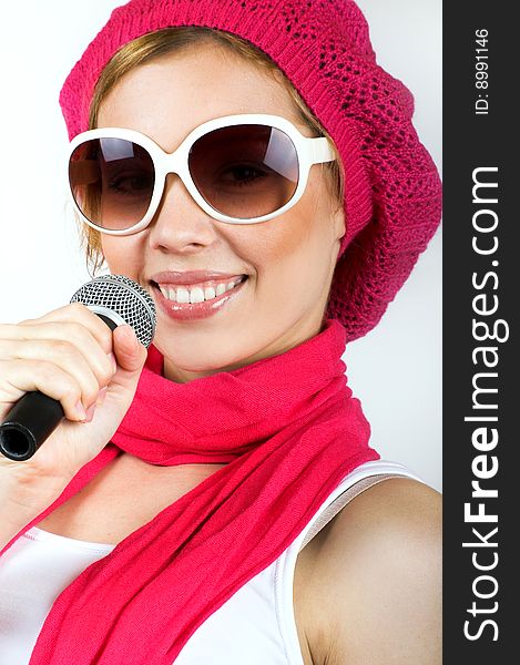 Portrait of a happy singing woman with a microphone and sunglasses. Portrait of a happy singing woman with a microphone and sunglasses