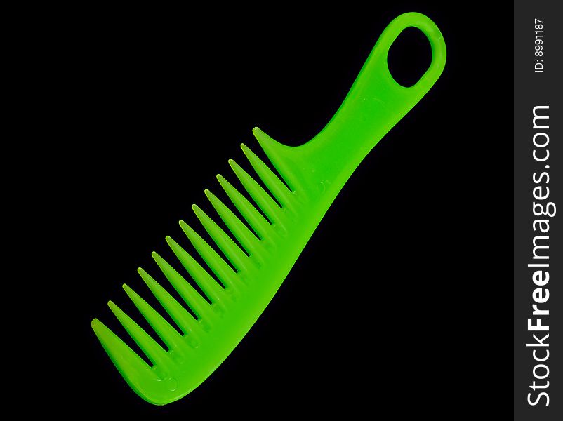 Green comb on black background