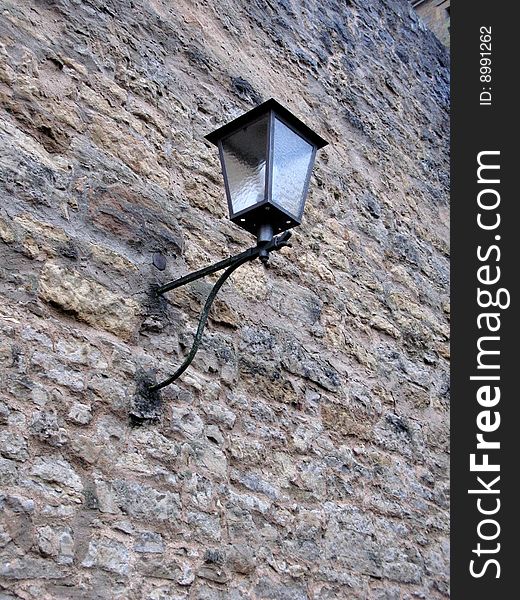 Forged street lamp on the wall
